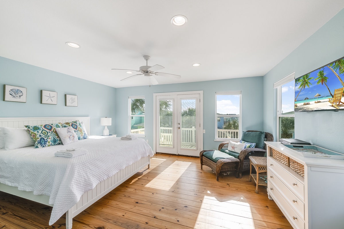 Wake up to ocean breezes in your serene coastal bedroom, where soft blues and warm wood floors create your perfect seaside retreat.
