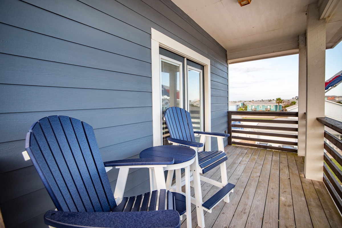 Unwind on your private balcony with comfortable Adirondack chairs and a perfect spot for morning coffee or evening relaxation.