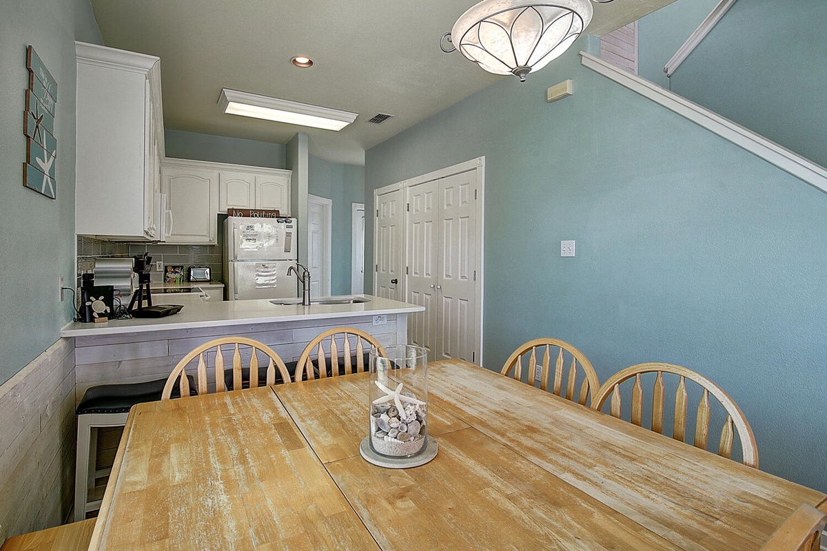 Gather around this spacious dining table for memorable meals with your group in the open kitchen area.