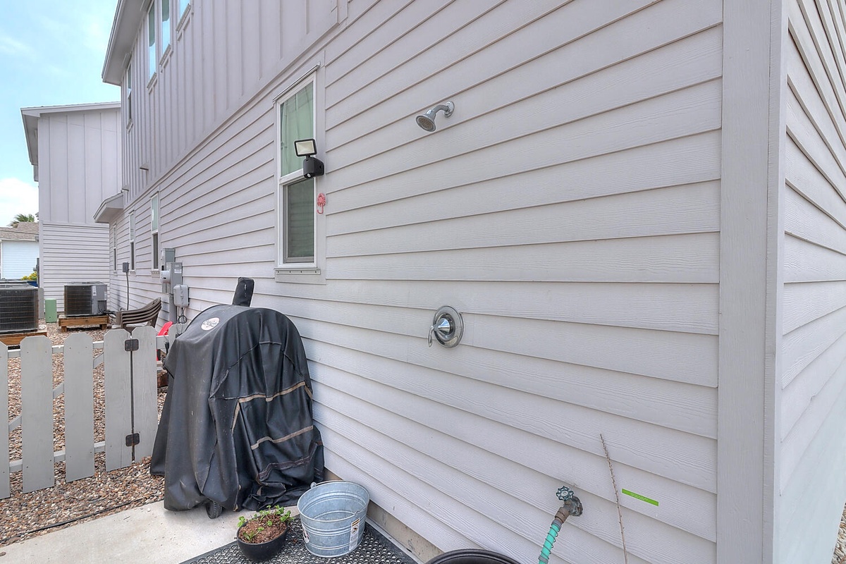 Modern beachside property with convenient outdoor shower for rinsing off after sandy adventures.