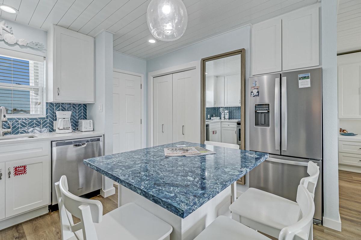 Your modern kitchen features stunning blue marble countertops, stainless steel appliances, and a beautiful herringbone backsplash perfect for cooking and dining.
