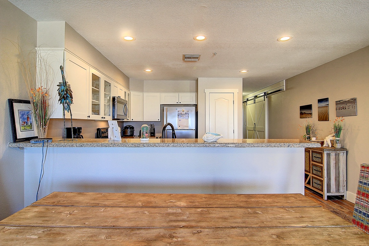 Your spacious kitchen features granite countertops, stainless appliances, and warm lighting perfect for preparing memorable meals during your stay.