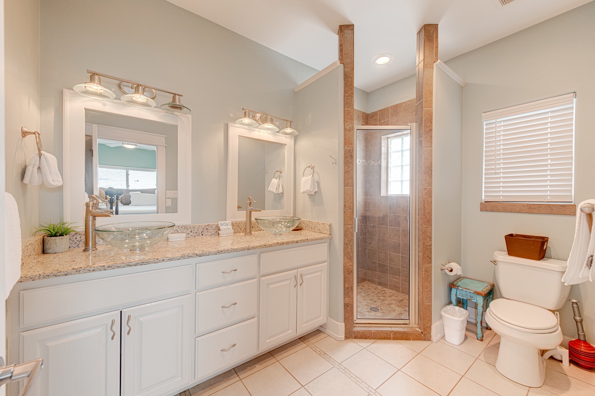 Unwind in your spacious bathroom with dual vanities, granite countertops, and a luxurious walk-in shower.