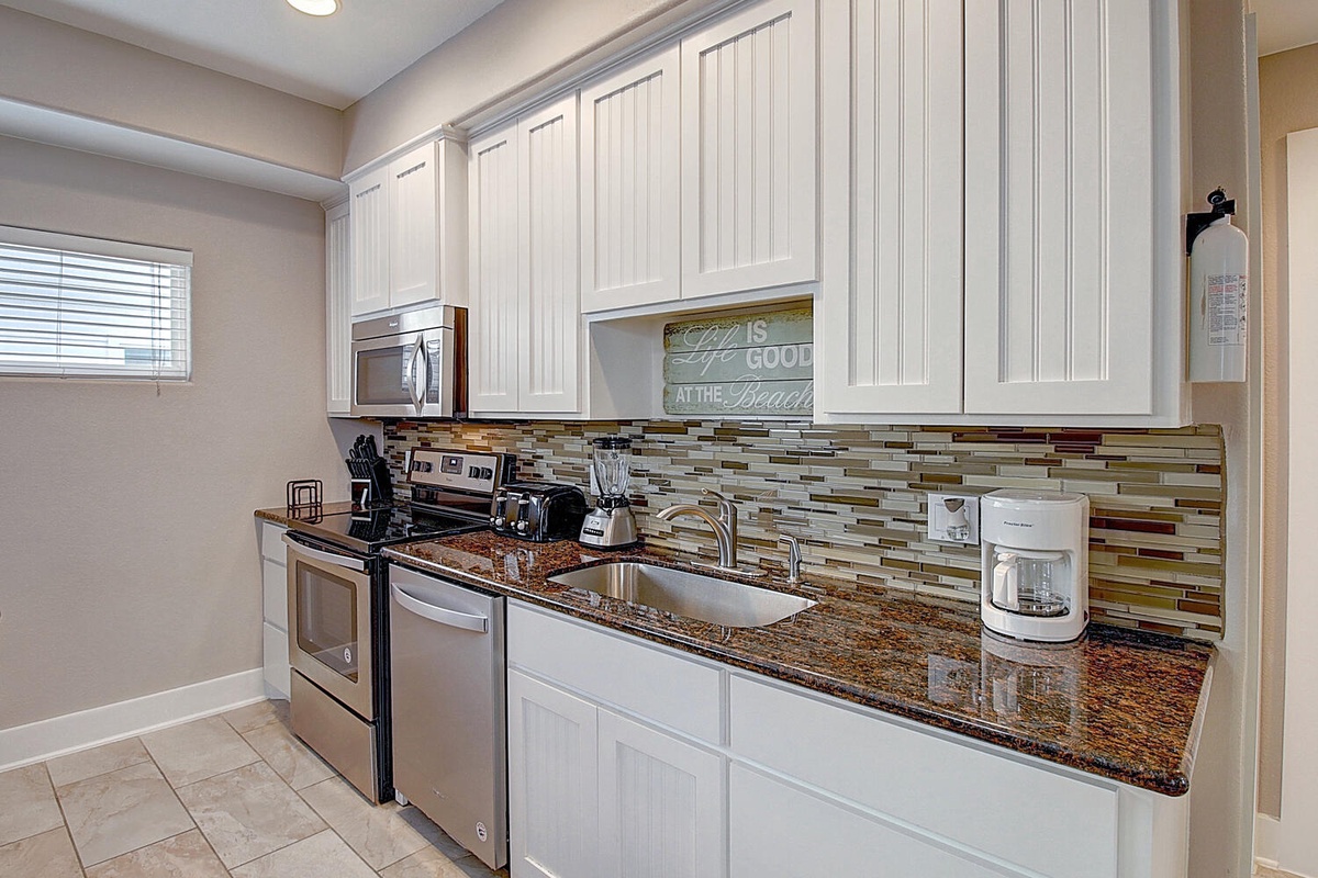 Your fully equipped kitchen features granite countertops, stainless appliances, and modern amenities ready for home cooking during your stay.