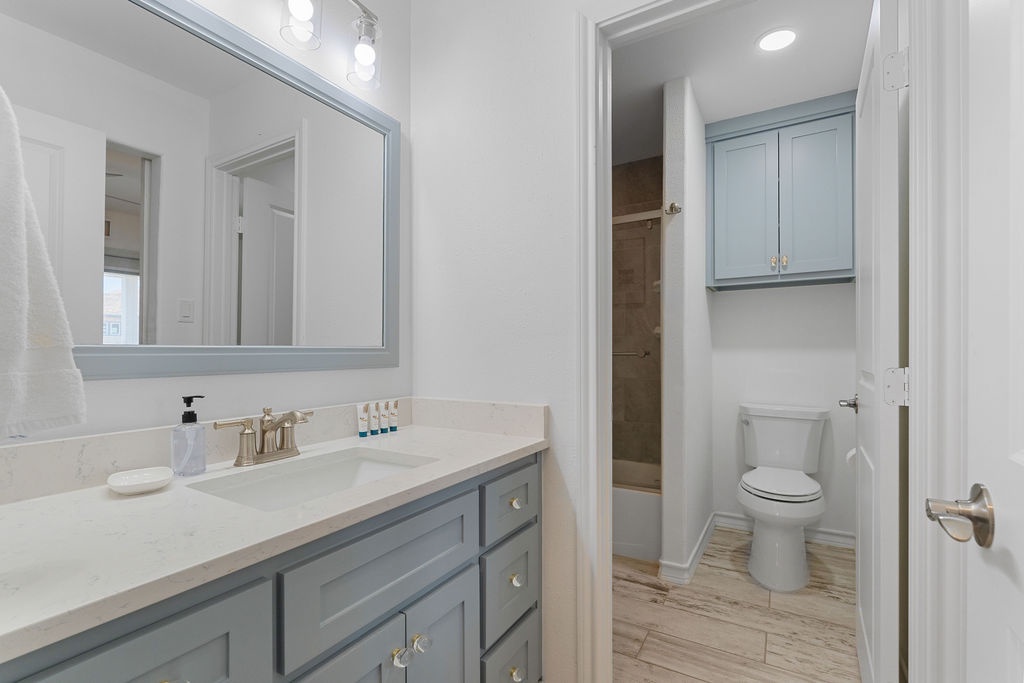Freshen up in your elegant bathroom featuring dual vanities, marble countertops, and a luxurious walk-in shower with modern finishes.