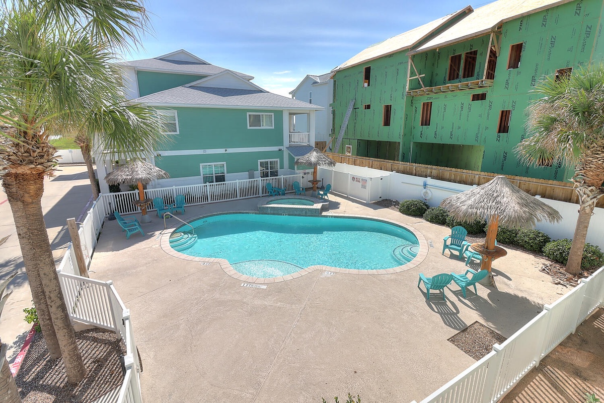Dive into your private oasis surrounded by swaying palms and colorful beach homes, where turquoise waters invite endless relaxation.