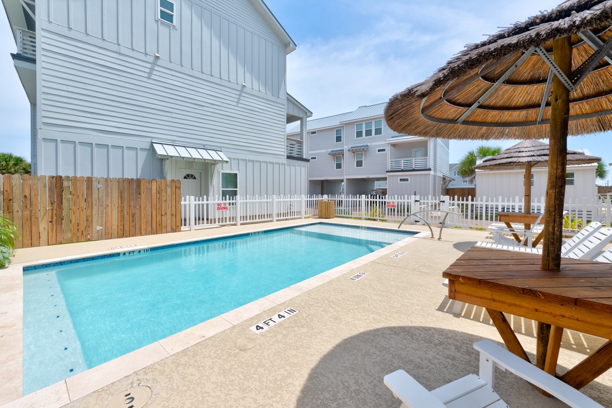 Dive into your private pool paradise, complete with tropical thatched umbrellas and loungers for ultimate relaxation under the Florida sun.