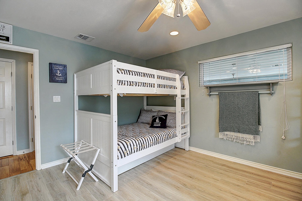 Your cozy bunk room features cheerful nautical touches and natural light, perfect for kids or extra guests to sleep soundly.