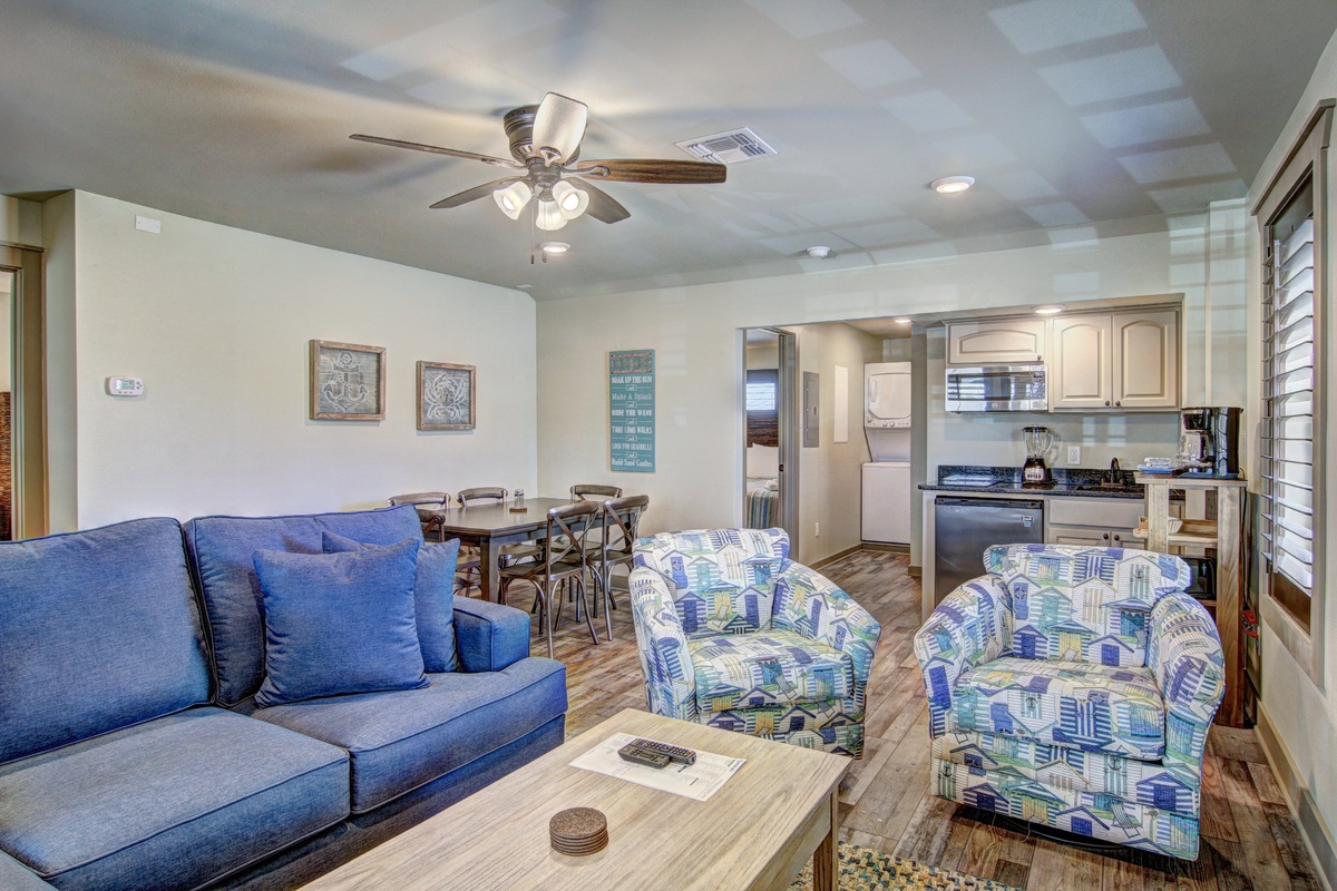 Unwind in your bright open living space where coastal blue furnishings and modern amenities create the perfect beach getaway atmosphere.