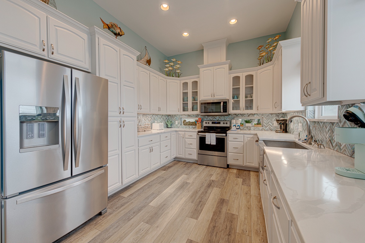 Your fully equipped gourmet kitchen awaits with stainless steel appliances, granite countertops, and plenty of space to create memorable meals together.