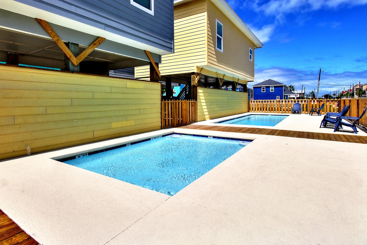 Dive into your private oasis with sparkling pools and sunny deck space, perfect for relaxing under endless blue skies.