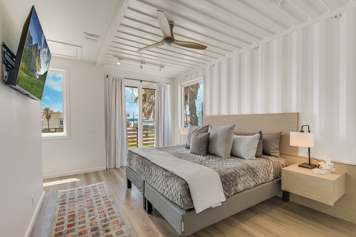Drift into peaceful sleep in your serene bedroom, where palm trees sway outside your window and modern comforts await.