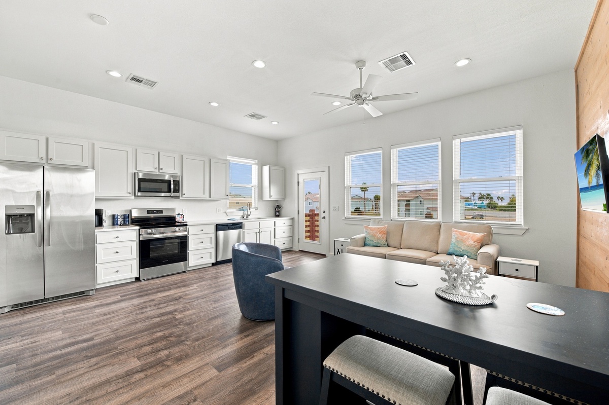 Gather around the sleek dining table or unwind on the cozy sofa as natural light pours through the windows, inviting you to relax in style.