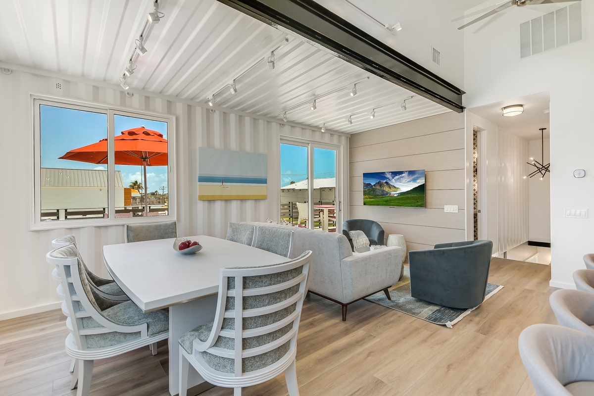 Relax in your stylish open-plan living space where coastal charm meets modern comfort, complete with panoramic windows showcasing ocean views.