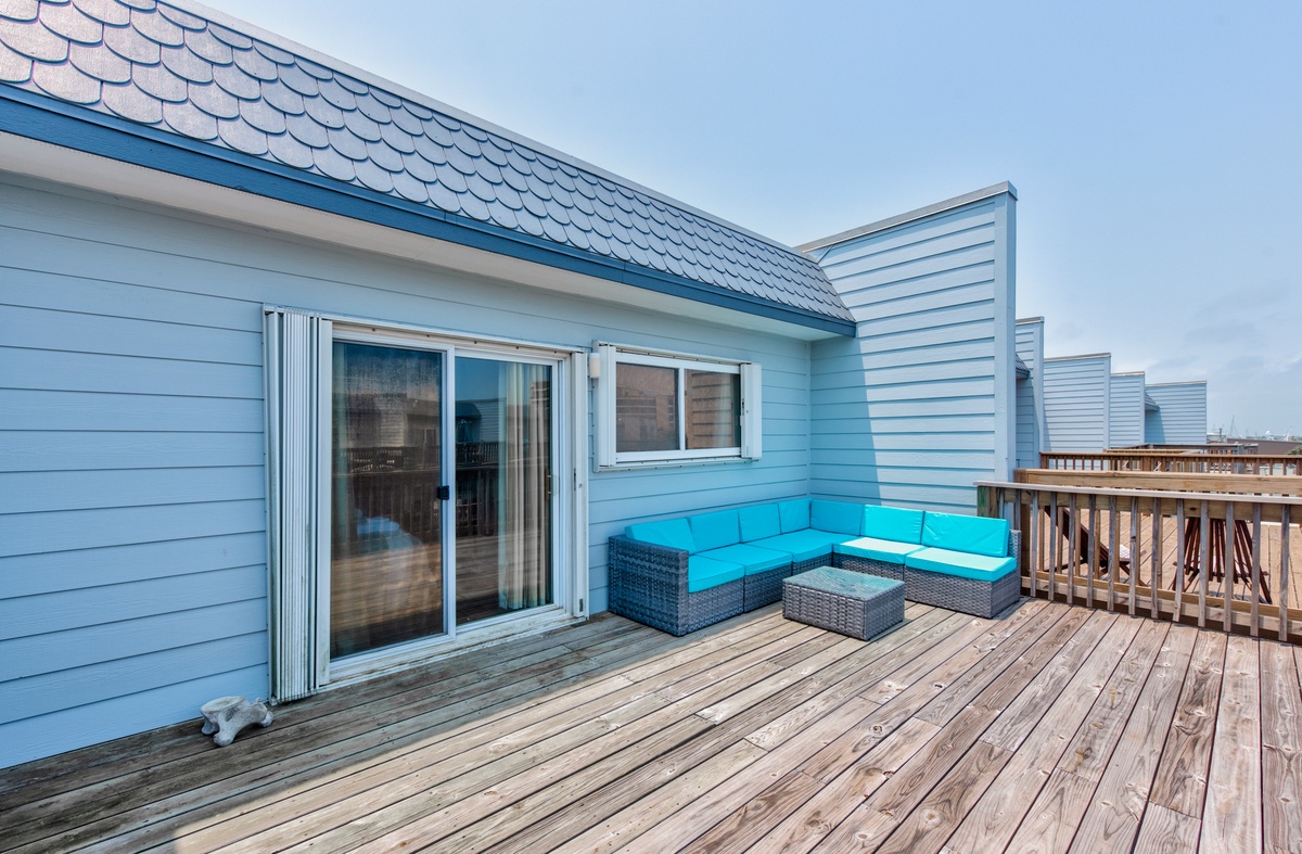 Unwind on your private deck with comfortable turquoise seating and direct access to your coastal retreat.