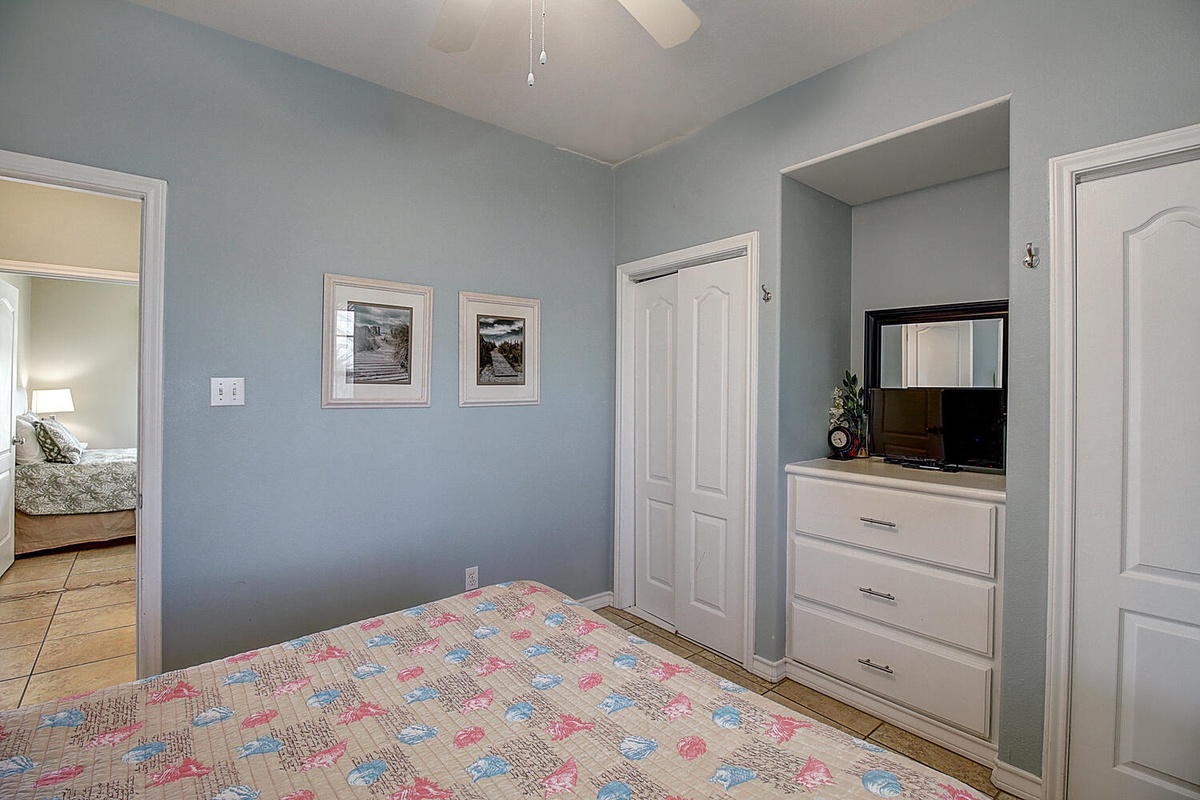 Drift off peacefully in your tranquil bedroom with soothing blue walls, convenient entertainment center, and ample storage for all your belongings.