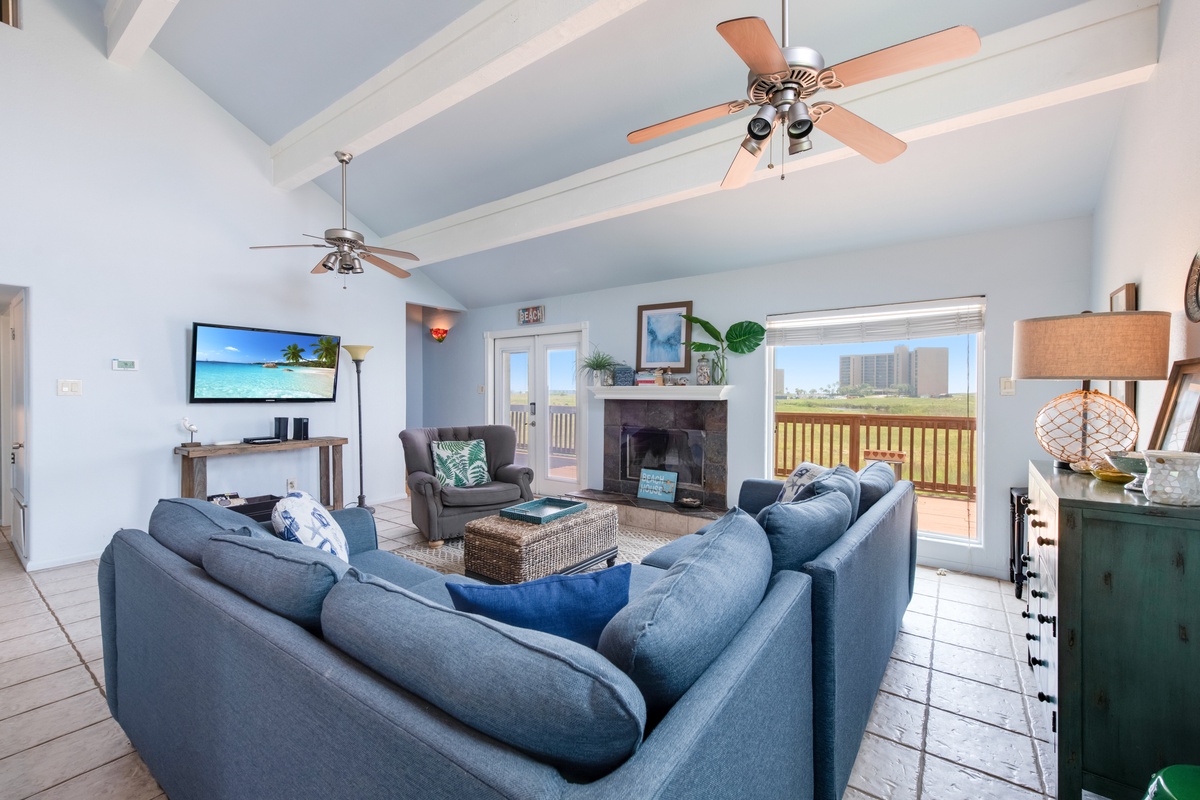 Relax in your spacious living room with vaulted ceilings, cozy fireplace, and comfortable seating perfect for gathering with loved ones.
