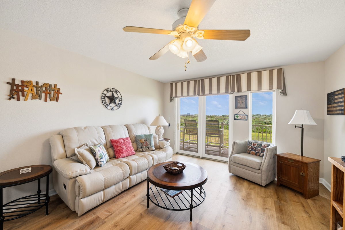 Relax in your inviting living room featuring comfortable seating and a bright space that opens to peaceful outdoor views, perfect for unwinding after a day of adventure.