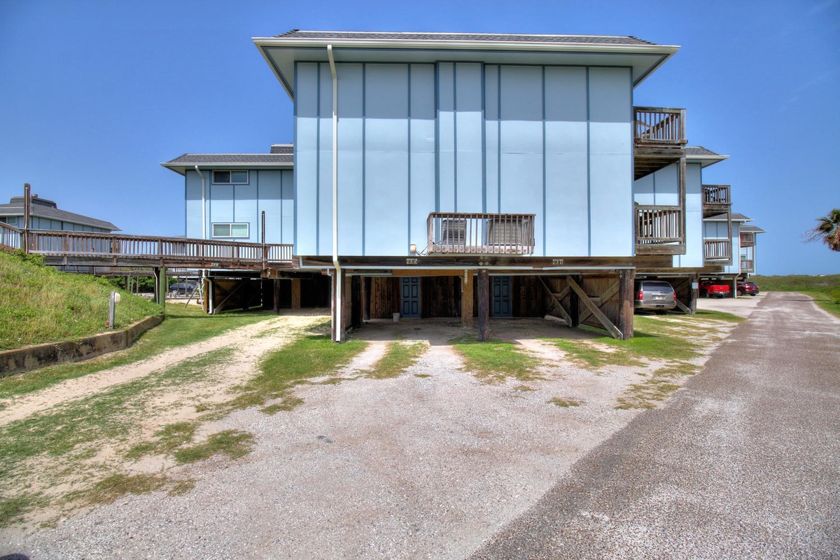Modern coastal vacation home features elevated design with multiple balconies and convenient ground-level parking.