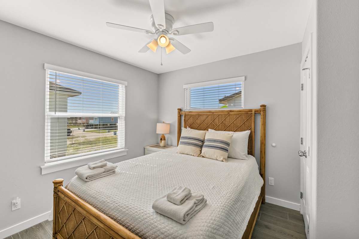 Your peaceful retreat features crisp linens on a comfortable bed, gentle ceiling fan breezes, and natural light streaming through your windows.