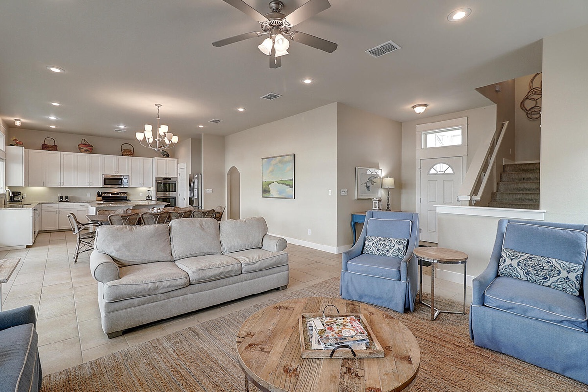 Relax in this spacious open-concept living area where coastal blues meet warm neutrals, perfect for unwinding after your adventures.