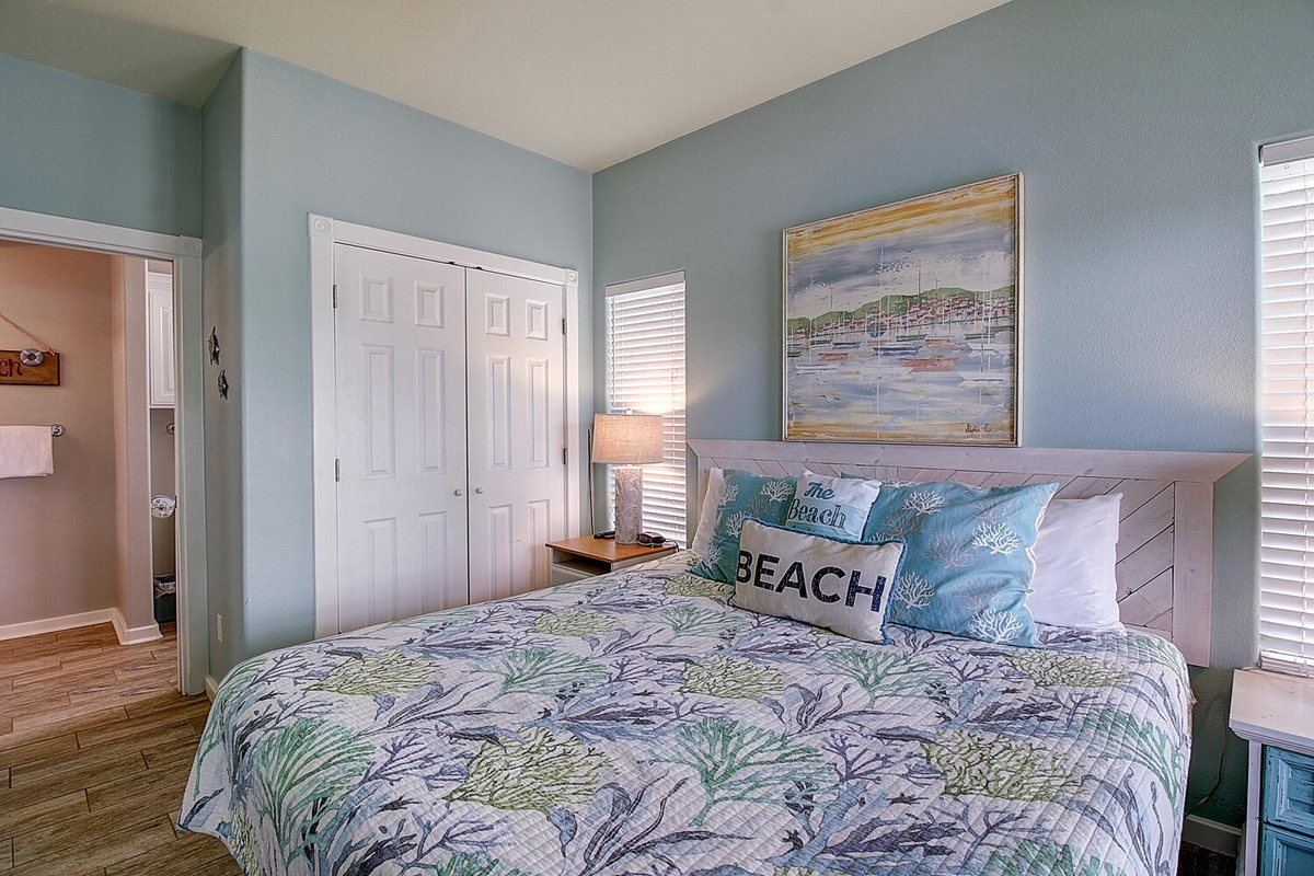 Drift off to peaceful dreams in your coastal-themed bedroom, where soothing blue walls and beach-inspired artwork create your perfect seaside retreat.