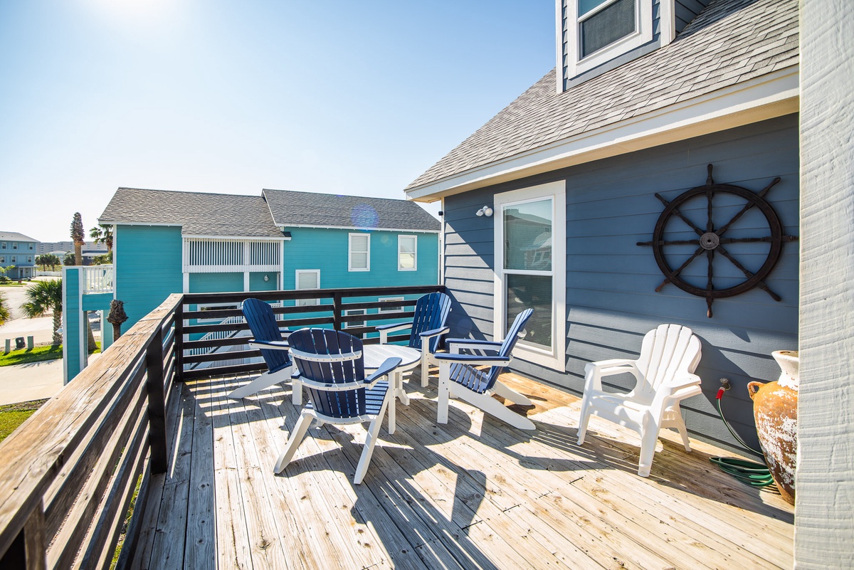 Step onto your private deck and sink into nautical-themed chairs while ocean breezes carry the sound of waves to your coastal retreat.