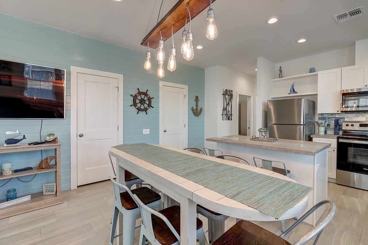 Your coastal-inspired kitchen beckons with nautical charm, modern appliances, and a spacious island perfect for morning coffee and evening meals together.