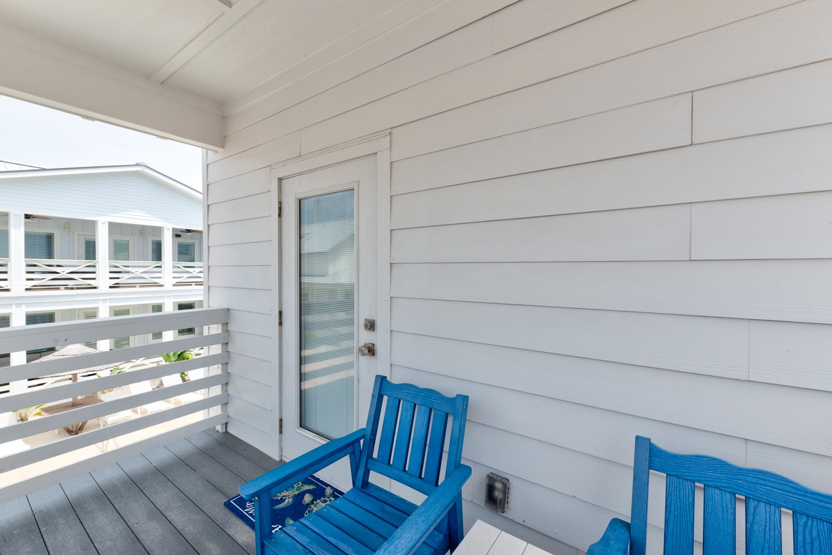 Settle into your private balcony with vibrant blue chairs, perfect for morning coffee or evening relaxation.