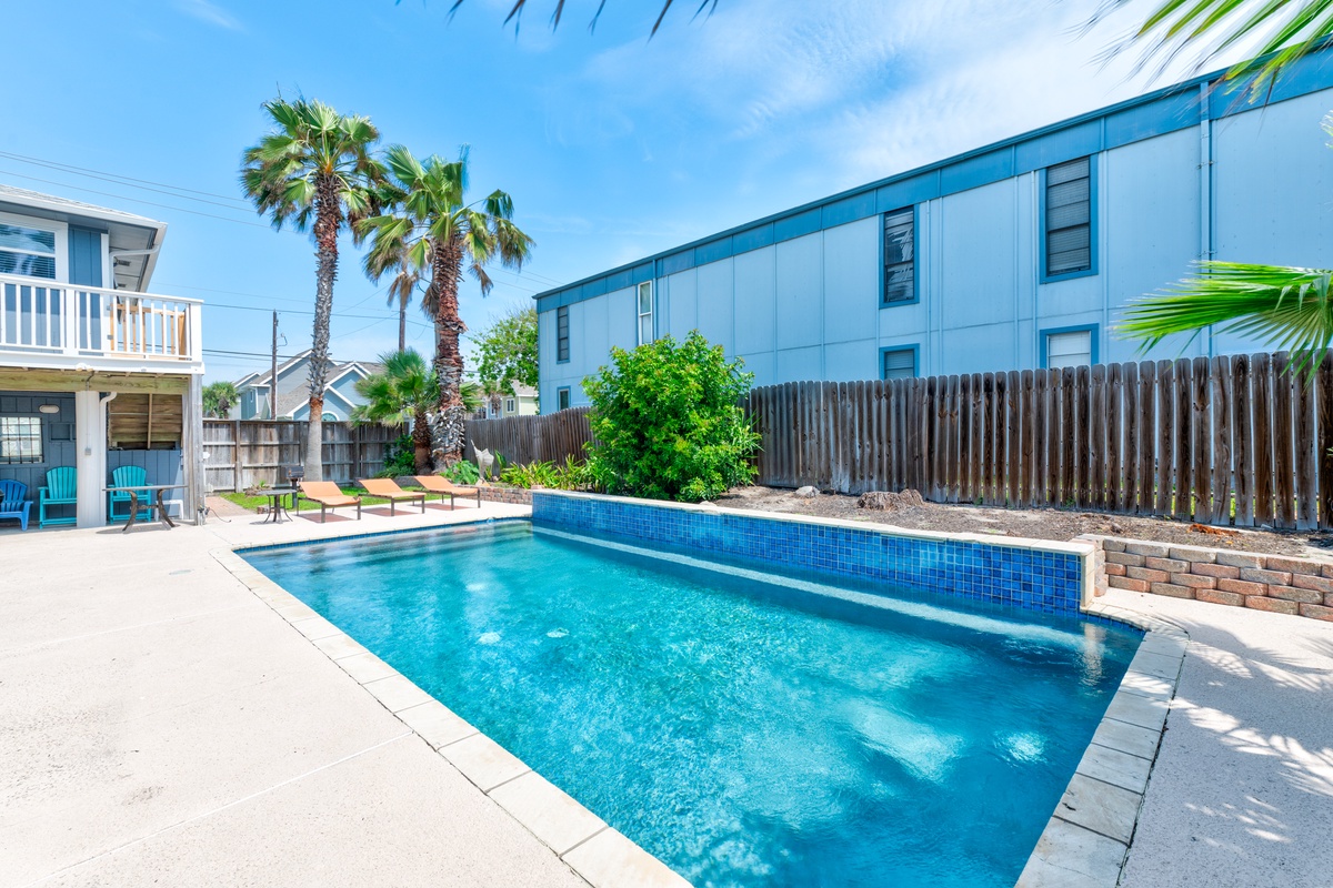 Dive into your private oasis! This sparkling pool beckons with crystal-clear waters, perfect for cooling off under swaying palms.