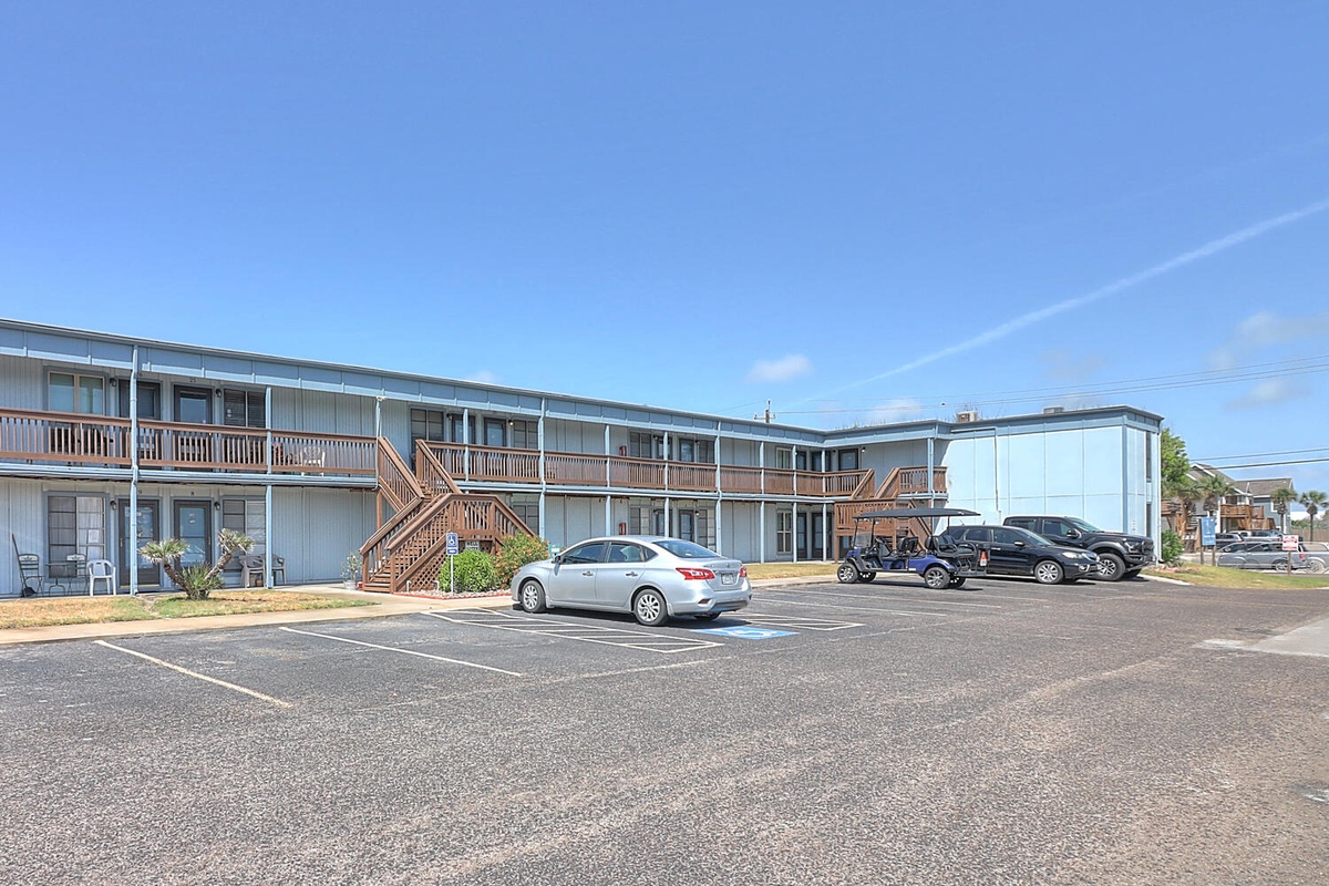 Two-story motel building with ample parking spaces conveniently located for easy check-in and access to rooms.