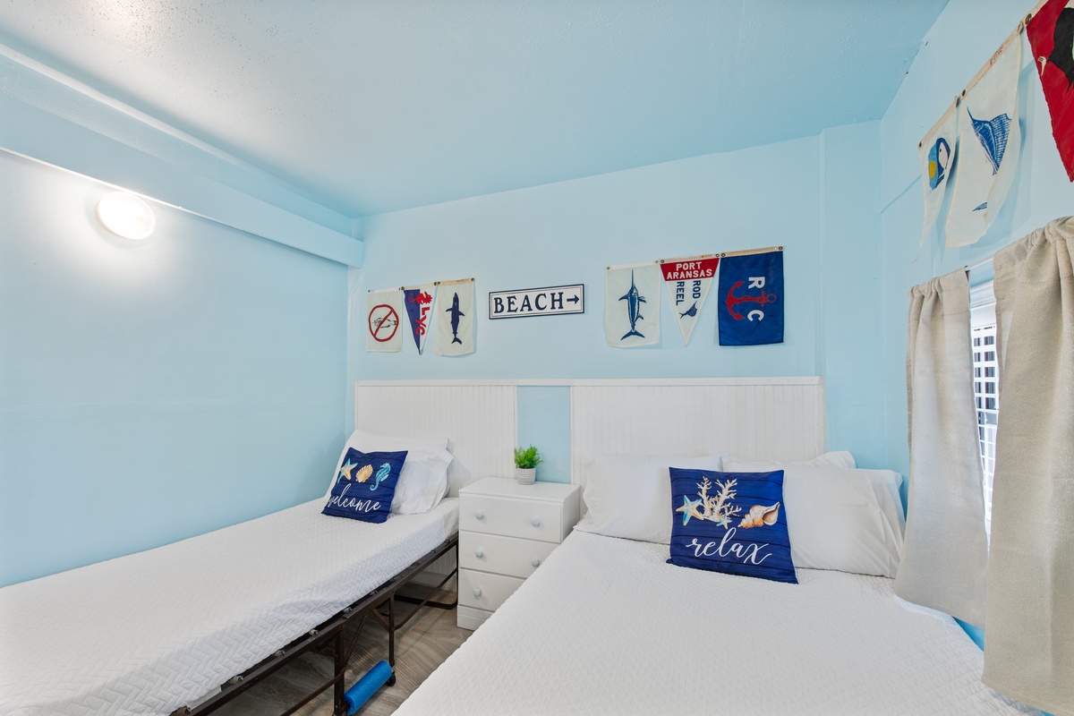 Drift off to sleep in your coastal-themed twin bedroom, where nautical flags and ocean-blue walls create a soothing seaside sanctuary.