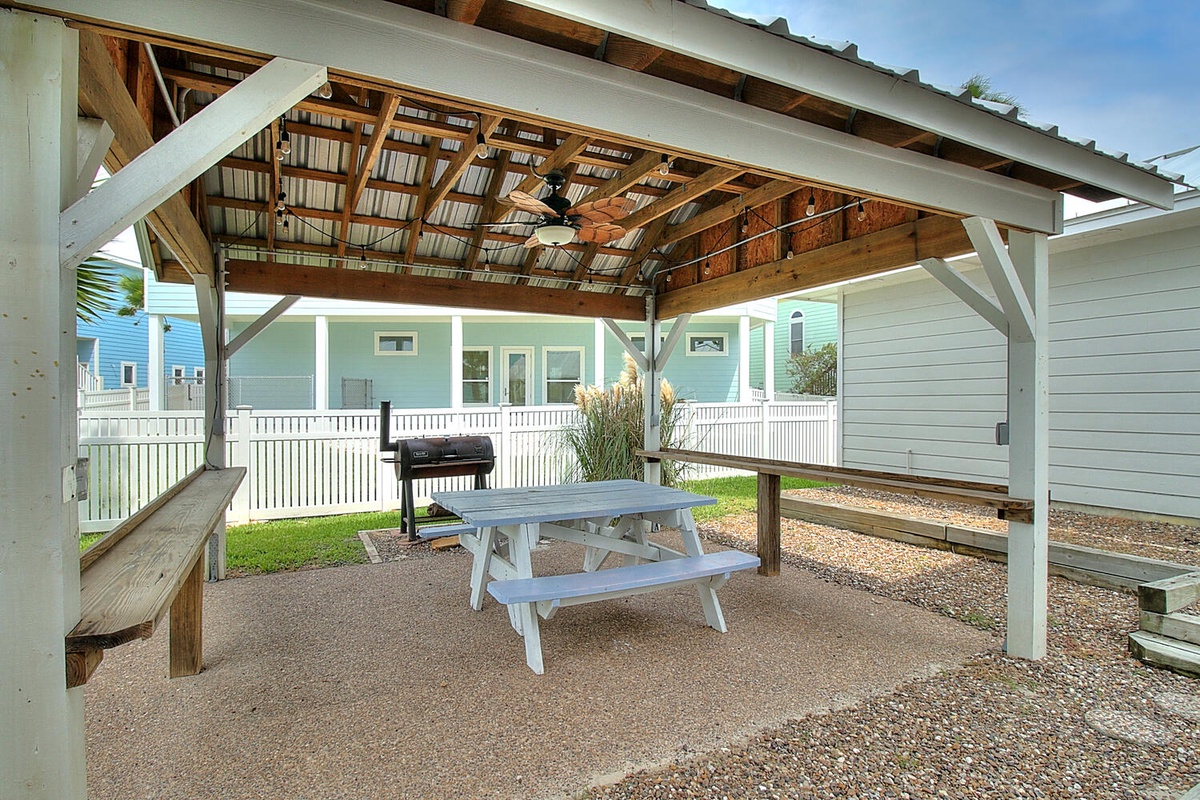 Gather around your private outdoor dining space, complete with picnic table and BBQ grill under a charming covered pavilion.