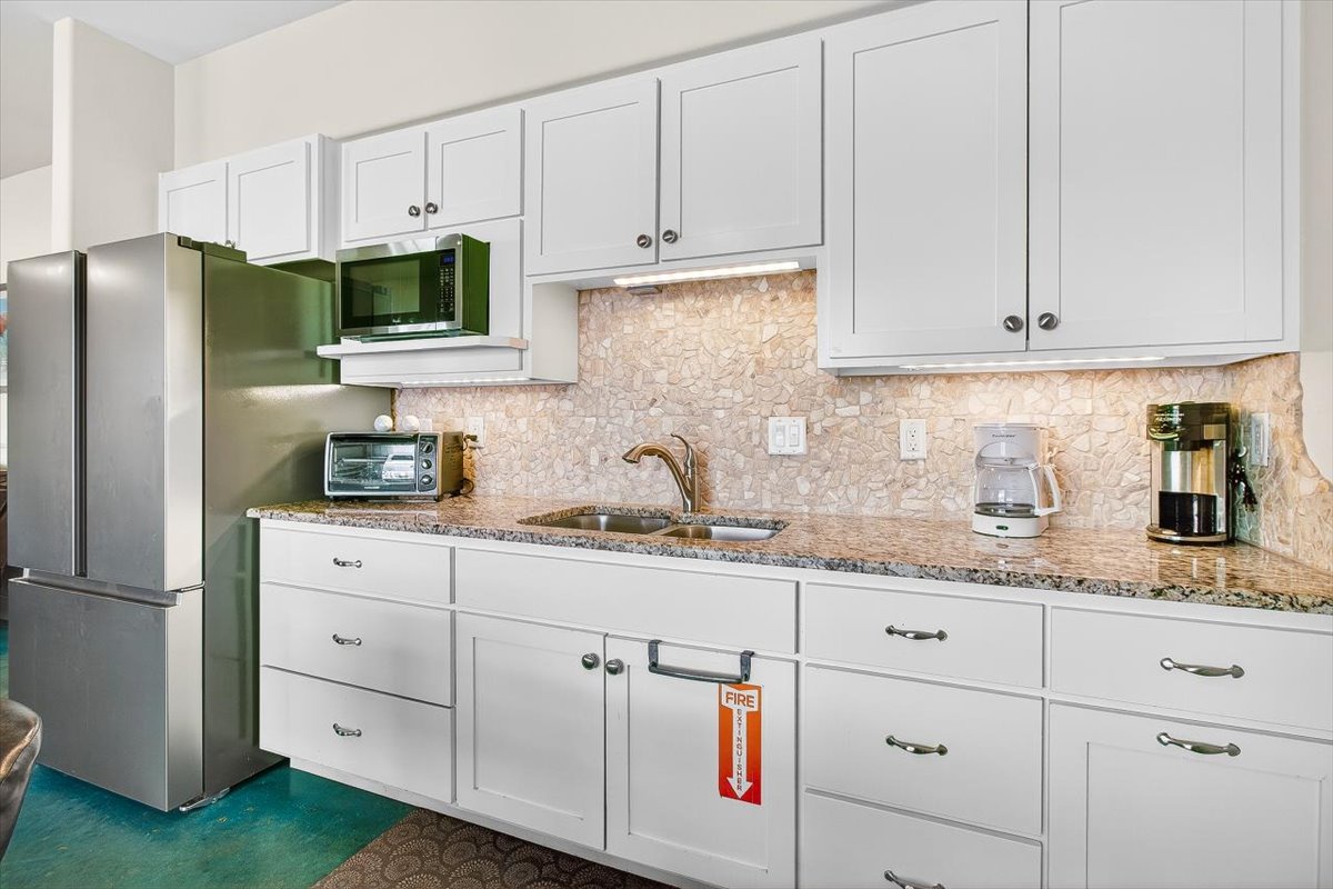 Your fully equipped kitchen features granite countertops, stainless appliances, and everything you need to prepare meals during your stay.