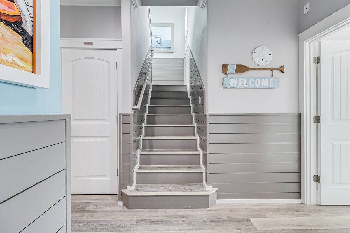 Step into your coastal retreat where nautical charm meets modern comfort in this bright, welcoming entryway.