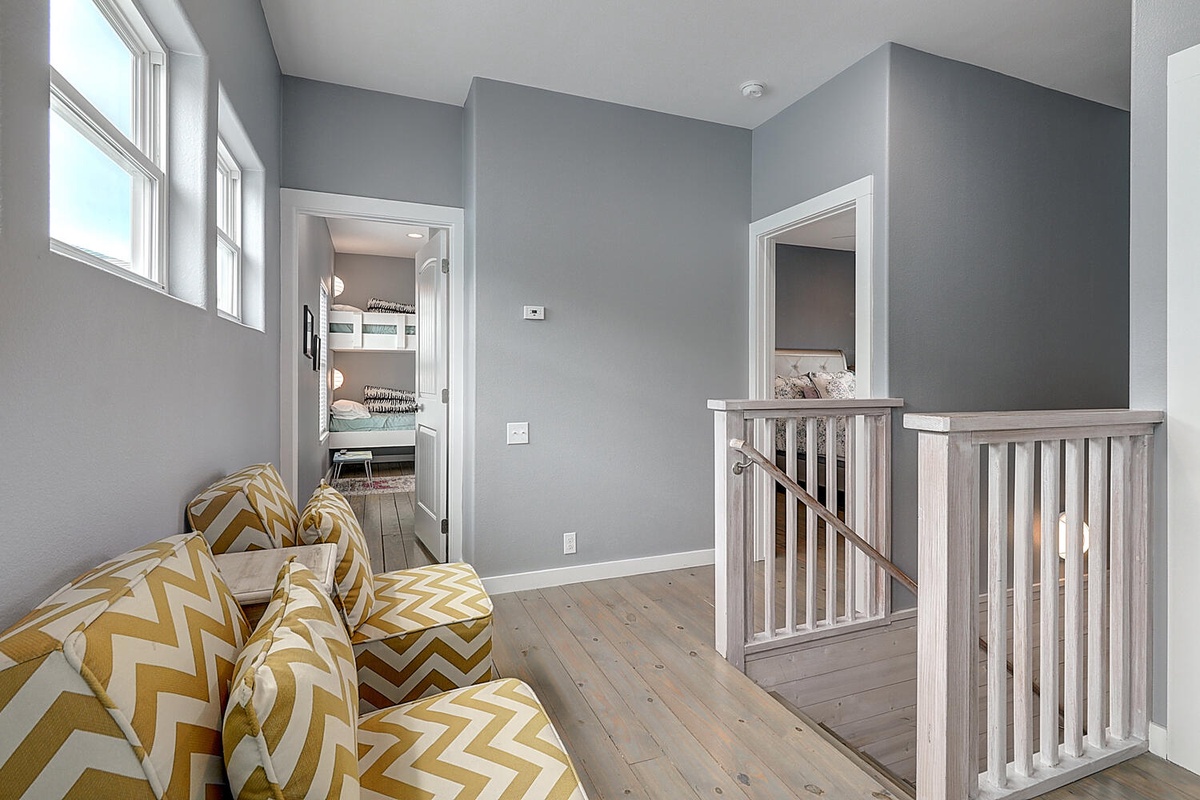 Sink into these cozy chevron chairs and feel at home in this bright, modern hallway connecting your private retreat.