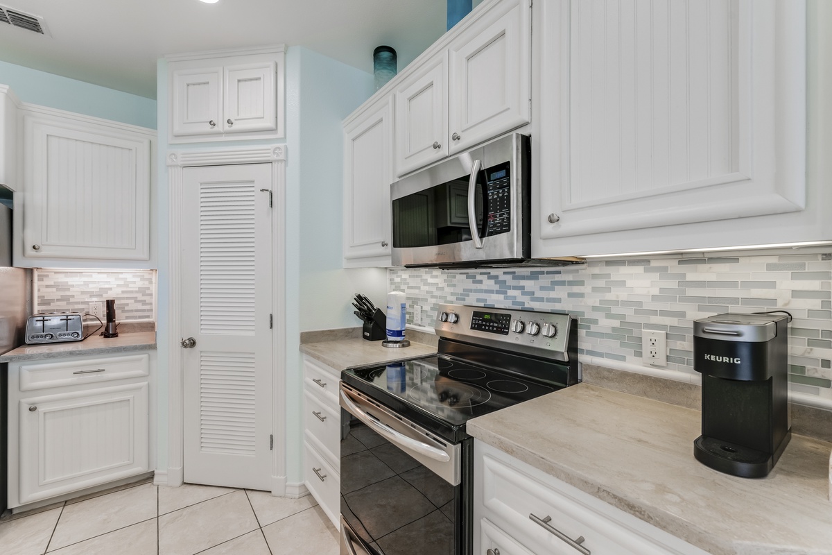Your fully equipped kitchen features pristine white cabinets, granite countertops, and stainless steel appliances for memorable meal prep.