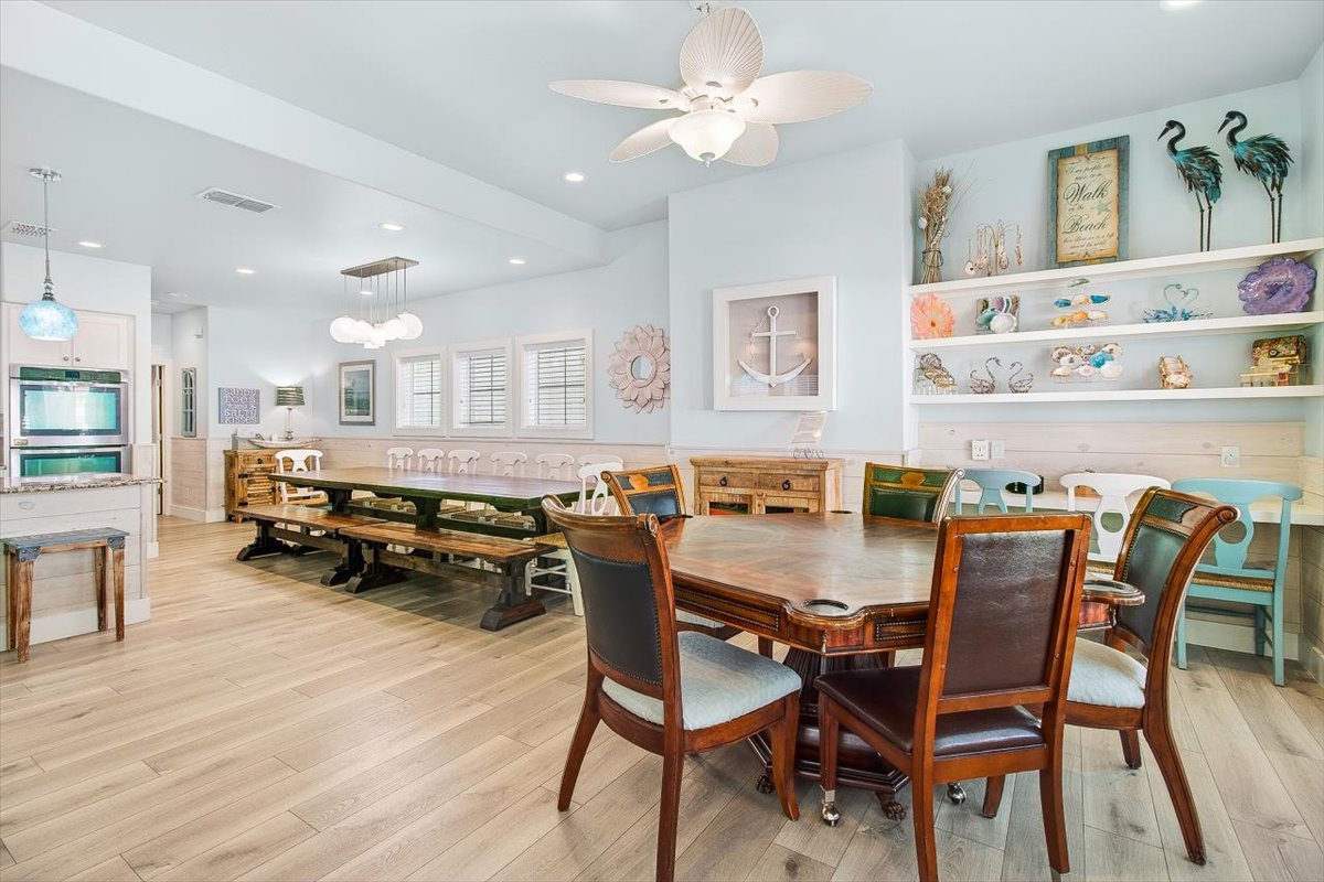 Gather around this spacious dining area where coastal charm meets comfort. Your family meals become memorable moments in this beautifully designed space.