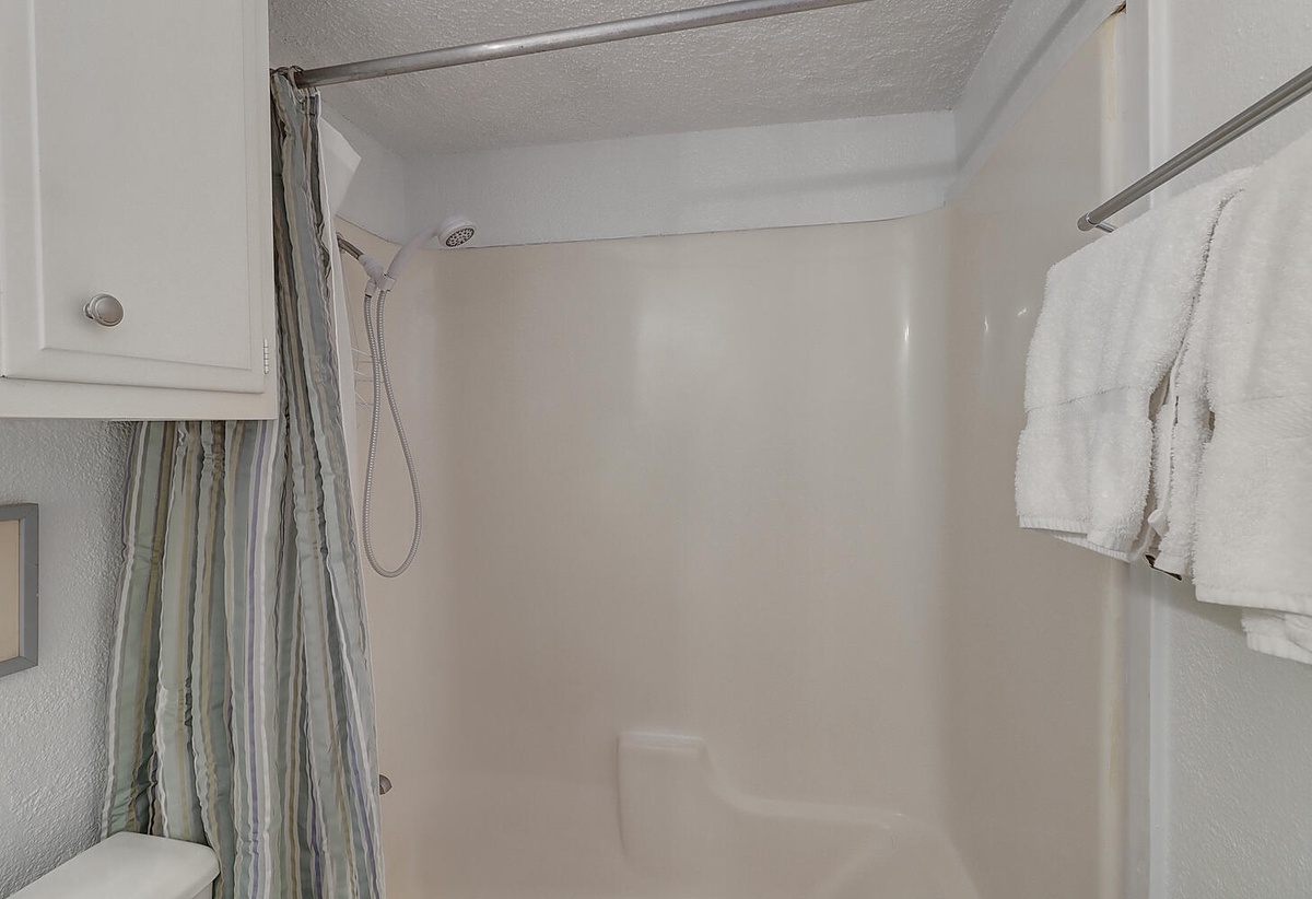 Step into your private shower with fresh towels waiting nearby, ready for a refreshing start to your day.