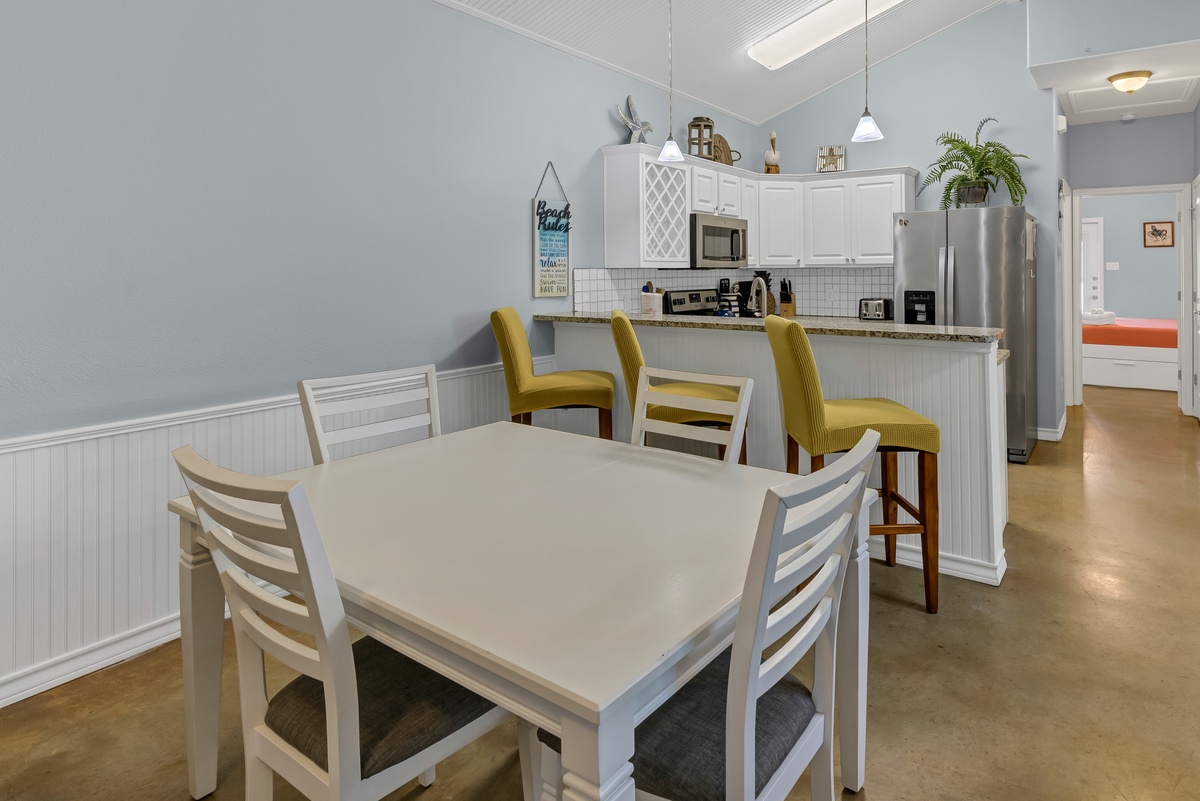 Your spacious dining area flows seamlessly into the fully equipped kitchen, perfect for sharing meals and creating memories together.