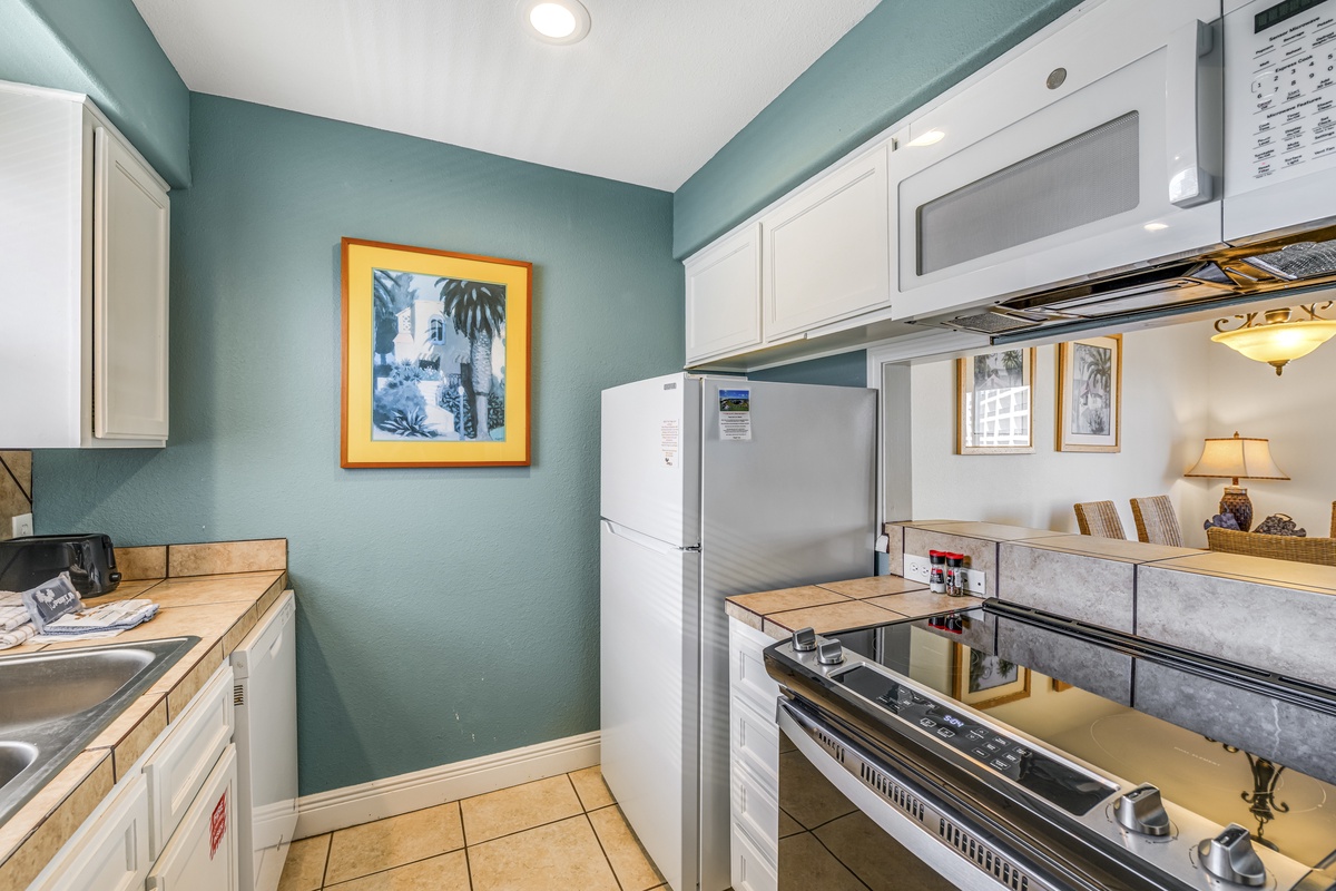 Your fully equipped kitchen invites you to create memorable meals with modern appliances and coastal charm.