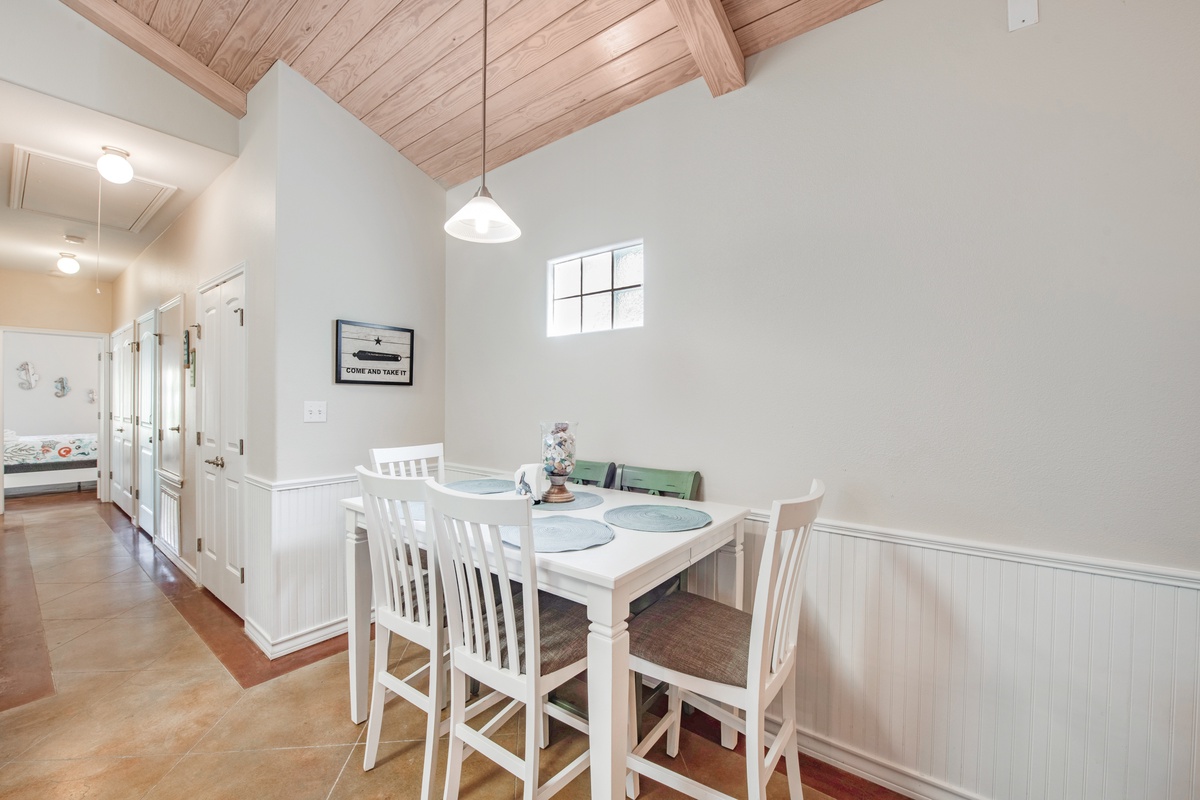 Your charming dining space awaits with beautiful exposed wood beams overhead and a cozy table perfect for morning coffee or evening meals together.