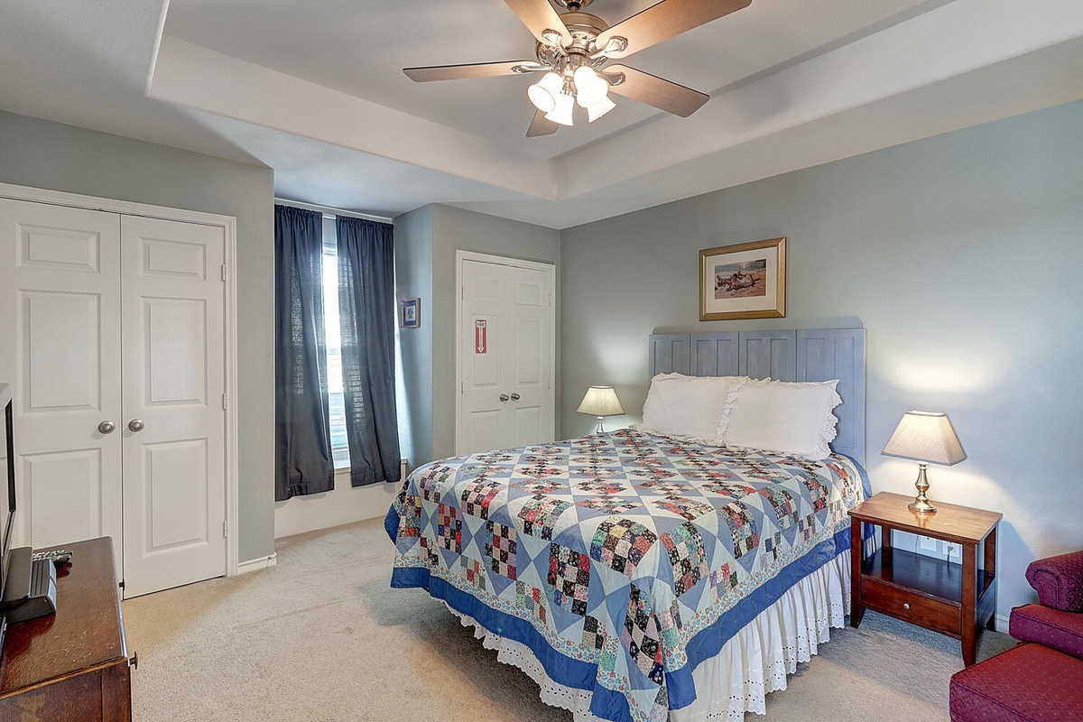 Your peaceful bedroom features a handcrafted quilt, soft lighting, and cozy furnishings that invite restful nights.