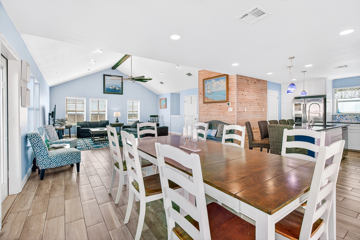 Gather around this spacious dining table where your coastal getaway memories begin, with room for everyone in this bright, beachy living space.