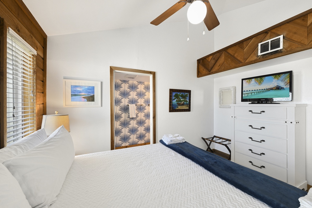 Sink into plush linens beneath vaulted wood-beam ceilings as coastal breezes stir through your serene, tropical-inspired retreat. Fresh towels and thoughtful touches welcome you home.