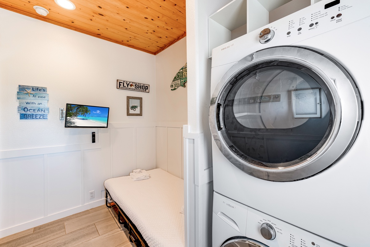 Cozy sleeping space with twin size rollway and easy access to the washer and dryer in the home.