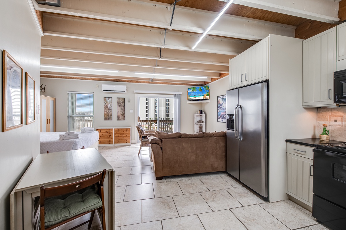 Relax in your bright, open-concept space with exposed beams, full kitchen, and comfortable living area.