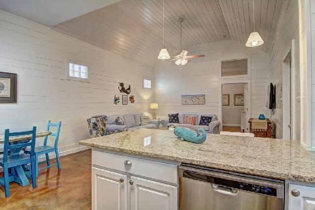 Unwind in your open kitchen-living space with granite counters, modern appliances, and cozy coastal charm.