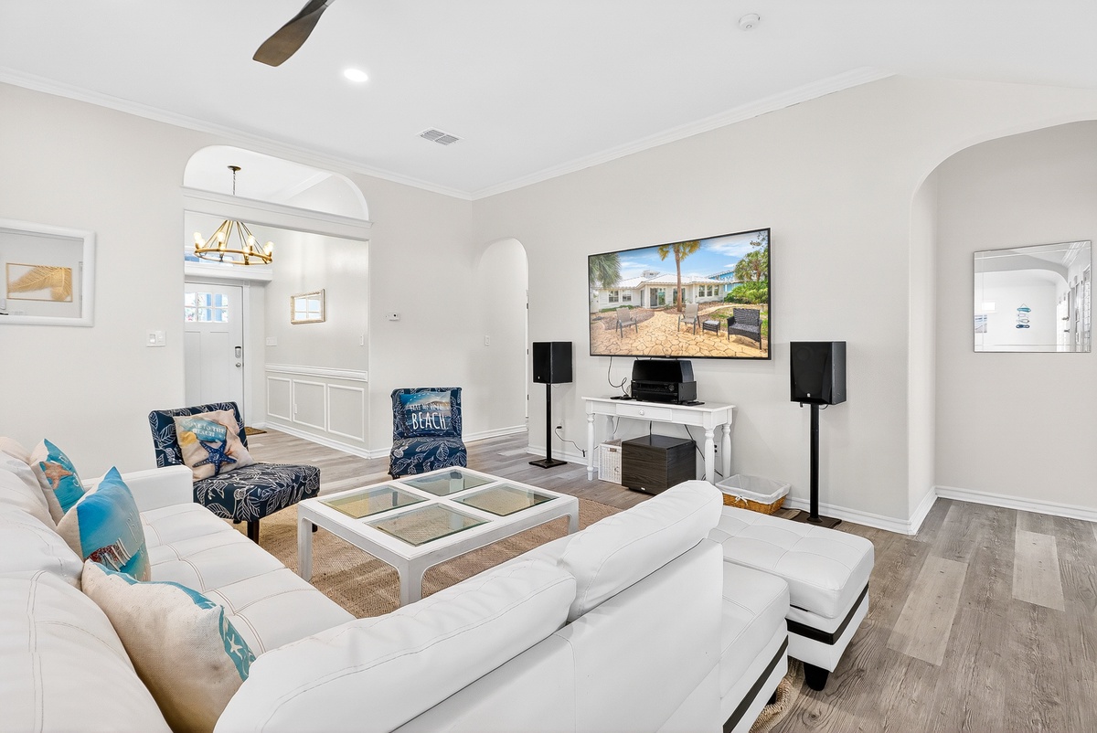 Unwind in your stylish living room featuring plush seating, entertainment center, and coastal-themed accents that create the perfect retreat.