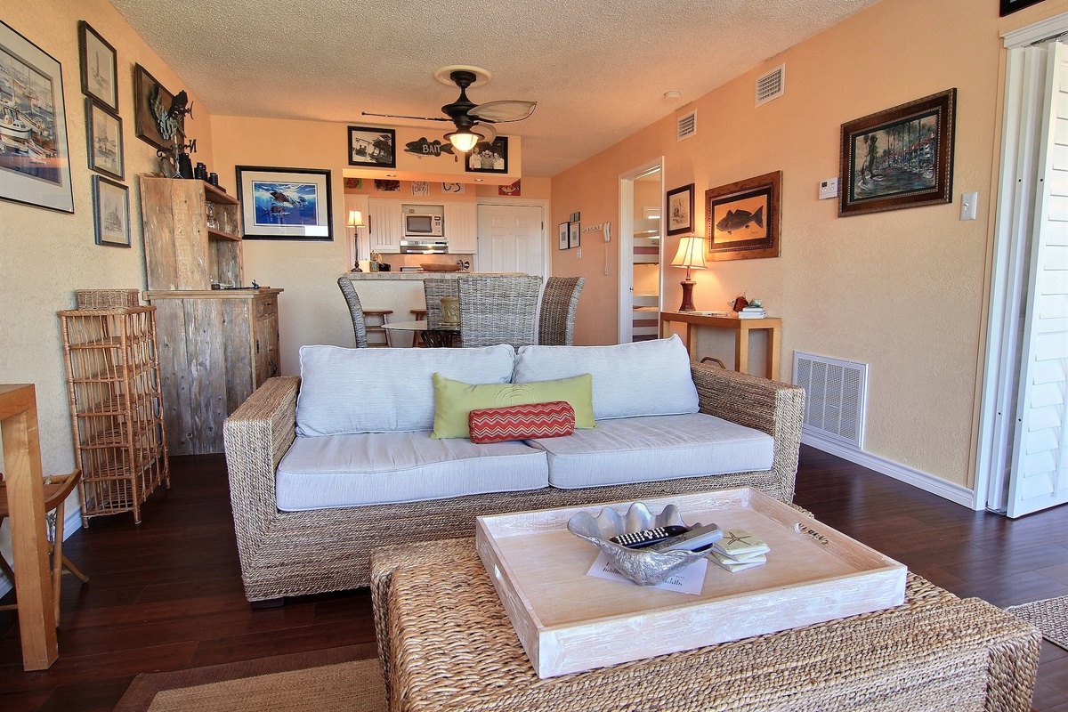 Sink into the wicker sofa and feel the coastal breeze from your ceiling fan as you unwind in this thoughtfully decorated space.
